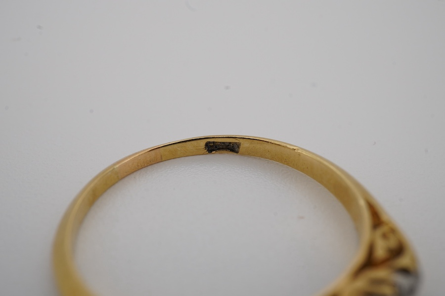 An early 20th century yellow metal and graduated five stone diamond set half hoop ring, size N, gross weight 2 grams. Condition - fair